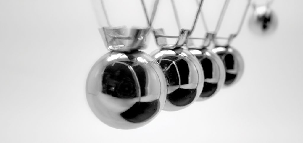 An image of Newton's pendulum containing five metal balls.