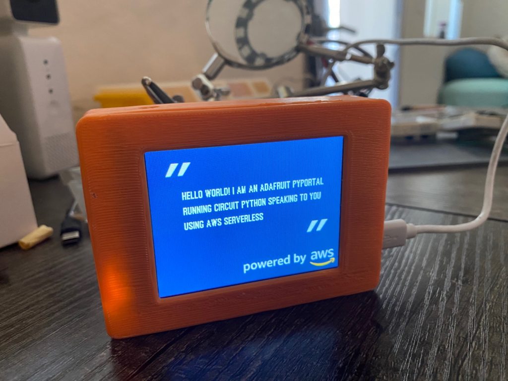 An Adafruit PyPortal displaying a quote while synthesizing and playing speech using Amazon Polly.