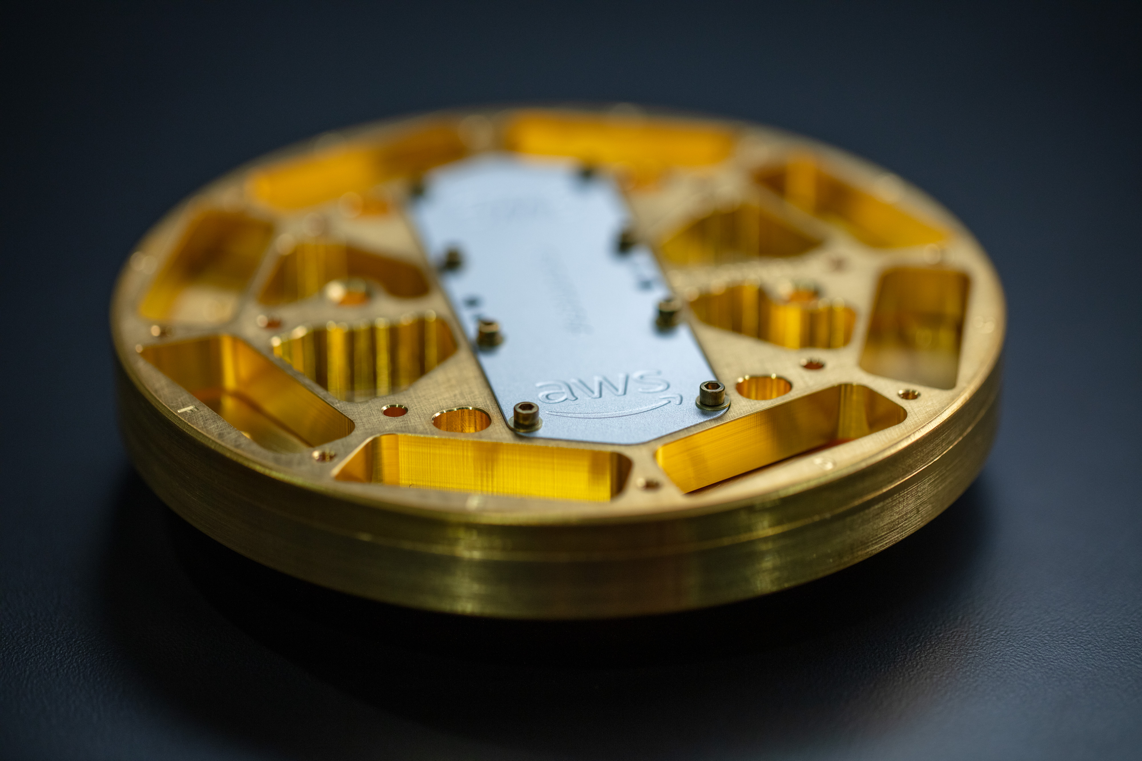 A microwave package encloses the quantum processor. The packaging is designed to shield the qubits from environmental noise while enabling communication with the control system.