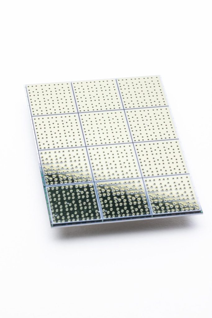 Figure 3: The Cepheus-1-108Q multi-chip processor, showing twelve 9-qubit chiplets tiled in a 3x4 array. Photo by Drew Bird.