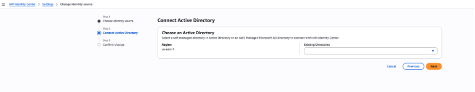 IAM Identity Center console: Change identity source wizard Step 2 — Connect Active Directory with Region set to us-east-1 and an Existing Directories dropdown.