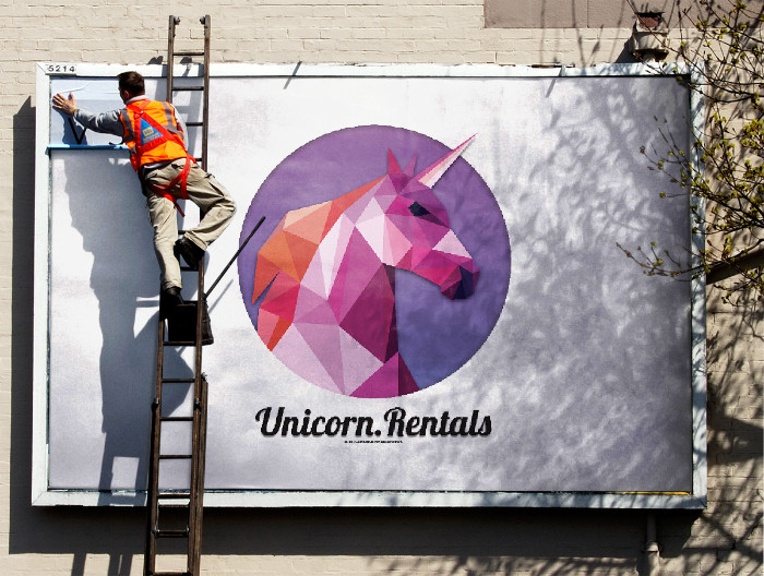 AWS GameDay billboard image displaying fictional unicorn at fictional company, Unicorn.Rentals on the billboard.