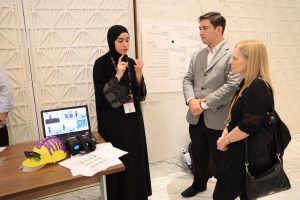 A student (left) hackathon participant explains how she intends to use Virtual Reality solutions and electroencephalogram ("brain scans"), powered by machine learning on AWS to understand and empathize with mental illness patients.