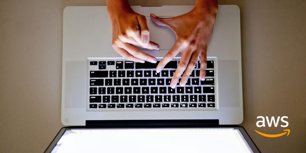 Person using a laptop with AWS logo superimposed.