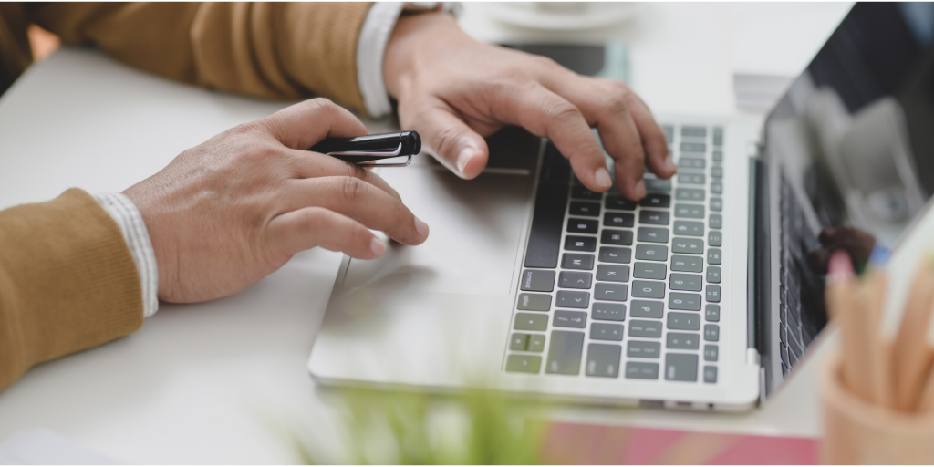 man on computer filing for UI