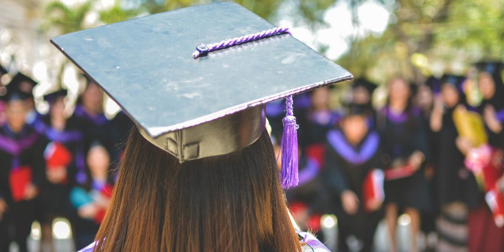 woman facing away from camera in graduation cap