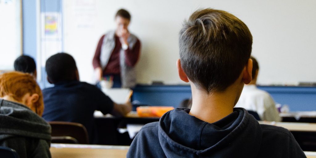 boy in classroom; Photo by Taylor Wilcox on Unsplash