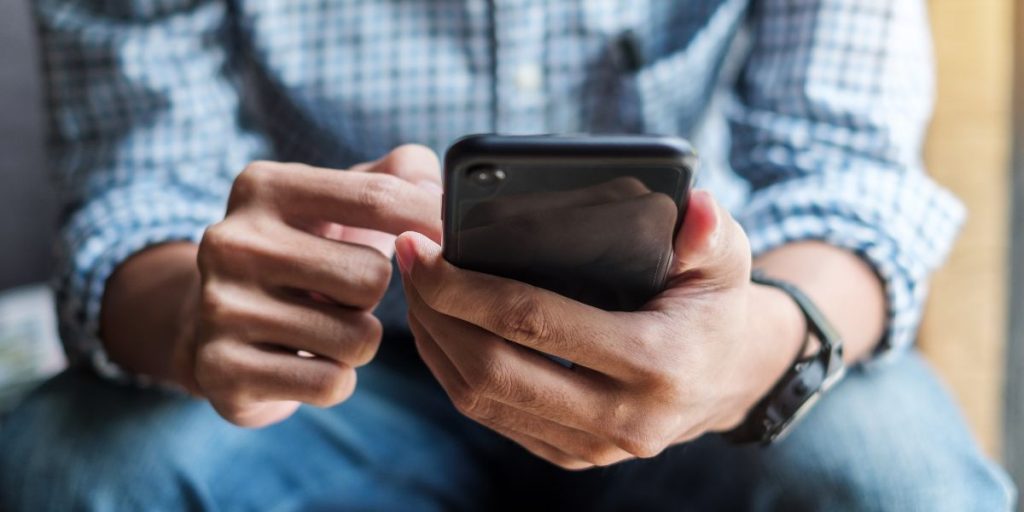 close up of man holding cell phone