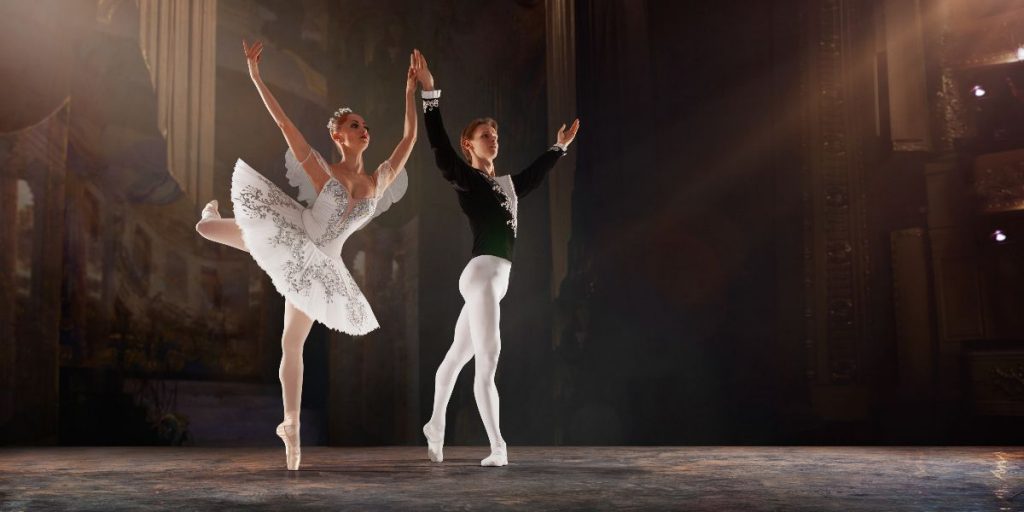 woman and man ballerinas perform on stage