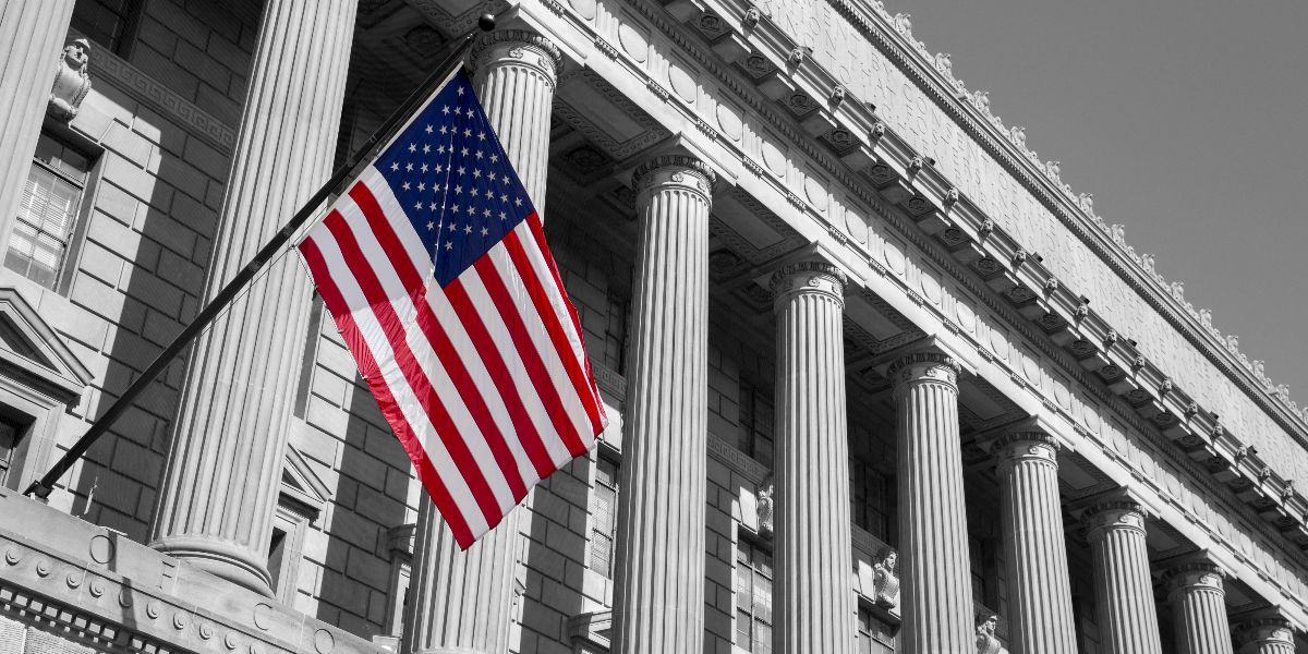 external photo of the US Department of Commerce with American flag