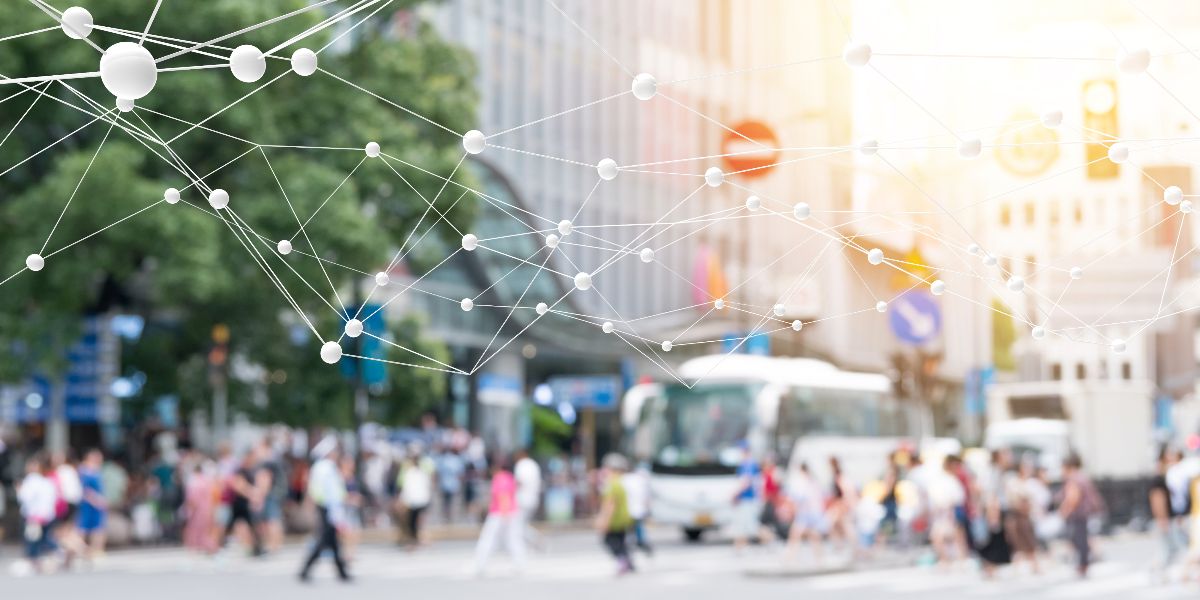 blurry photo of people crossing busy street in a city overlayed with connecting dots