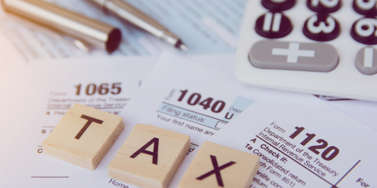 tax forms with calculator on table top