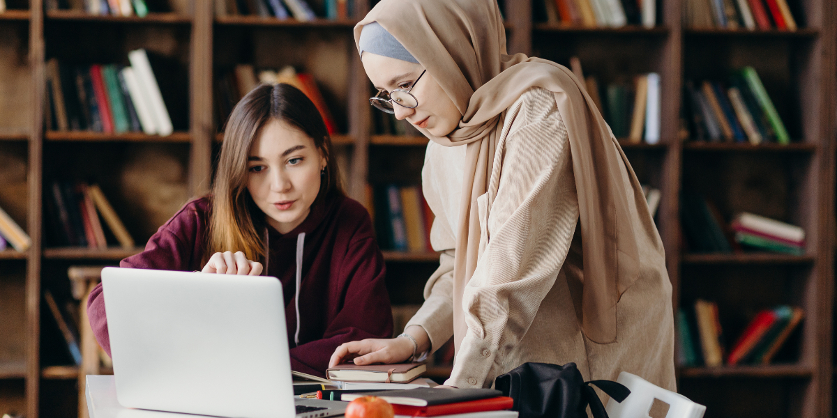 two women collaborate in a university library