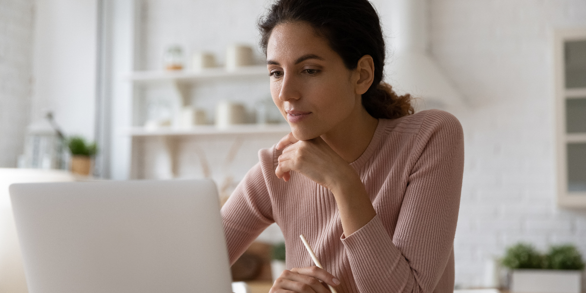 woman studies on laptop at home