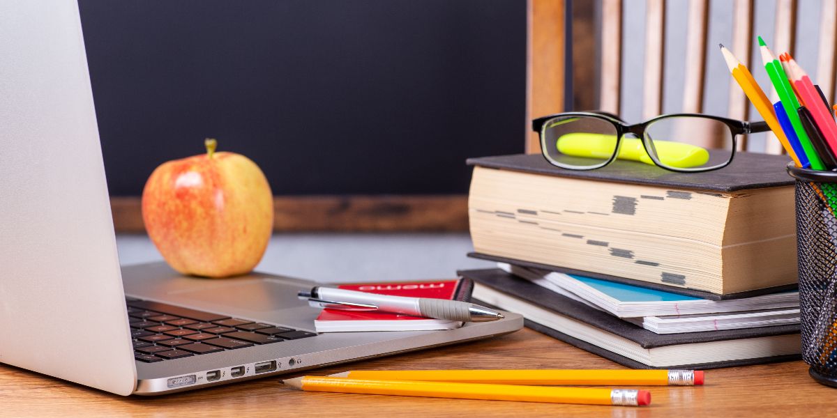 A computer on a teacher's desk in a K12 classroom.