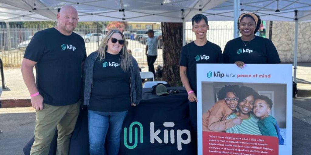 Kiip employees at an outdoor event where they are informing others about their solution