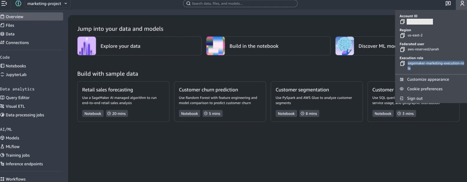 Amazon SageMaker Unified Studio marketing-project dashboard displaying left navigation menu with Overview, Files, Data, Connections, Code (Notebooks, JupyterLab), Data analytics (Query Editor, Visual ETL, Data processing jobs), and AI/ML sections (Models, MLflow, Training jobs, Inference endpoints); main content area showing "Jump into your data and models" with three quick-start cards (Explore your data, Build in the notebook, Discover ML models) and four sample data projects: Retail sales forecasting (20 mins), Customer churn prediction (5 mins), Customer segmentation (8 mins), and Customer usage analysis (3 mins); top-right panel displaying account details with us-east-2 region, federated user aws-reserved/sarah, and execution role sagemaker-marketing-execution-role. 