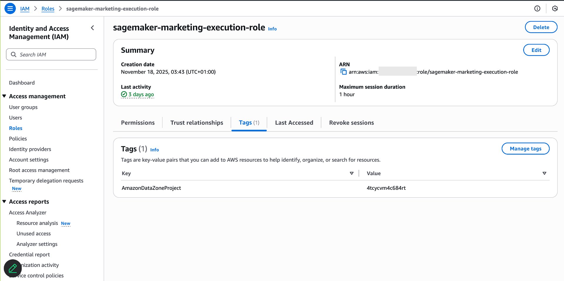 AWS IAM console displaying sagemaker-marketing-execution-role details page with Summary section showing creation date November 18, 2025, last activity 3 days ago, ARN arn:aws:iam::role/sagemaker-marketing-execution-role, 1-hour maximum session duration, five tabs (Permissions, Trust relationships, Tags (1), Last Accessed, Revoke sessions), and Tags section displaying one tag with Key "AmazonDataZoneProject" and Value "4tcycvm4c684rt" with Delete, Edit, and Manage tags buttons available. 