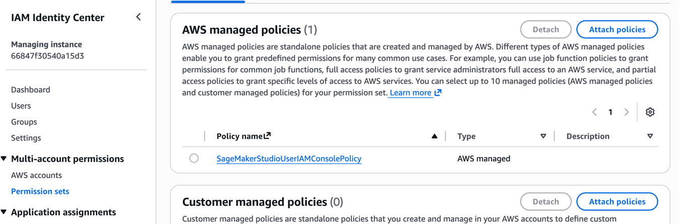 AWS IAM Identity Center console screenshot showing AWS managed policies section with one attached SageMakerStudioUserIAMConsolePolicy and empty customer managed policies section with detach and attach policy options available.