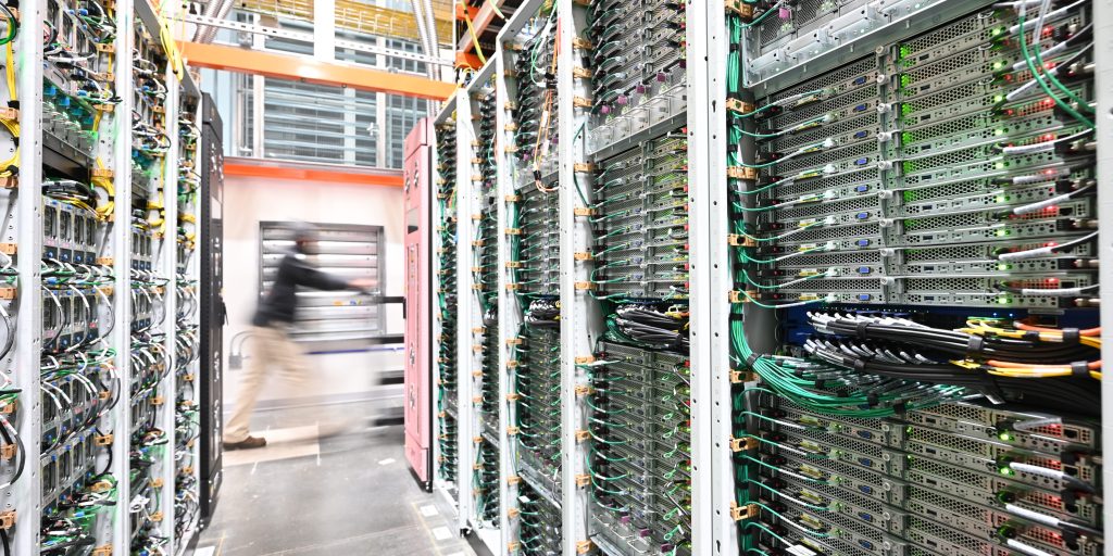 photo of AWS data center with a person moving in the background.