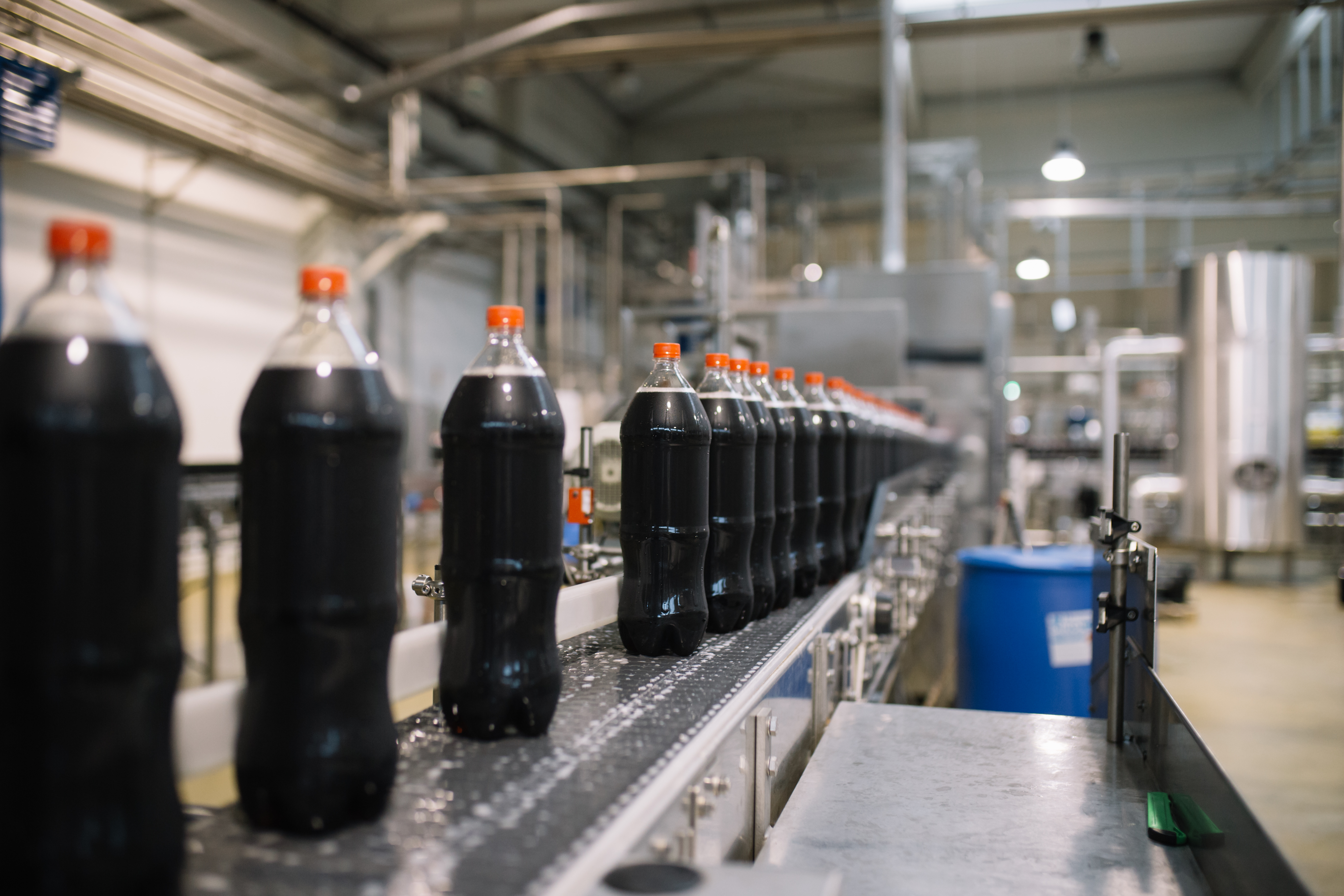 Bottling factory - Coke bottling line for processing and bottling juice into bottles. Selective focus.