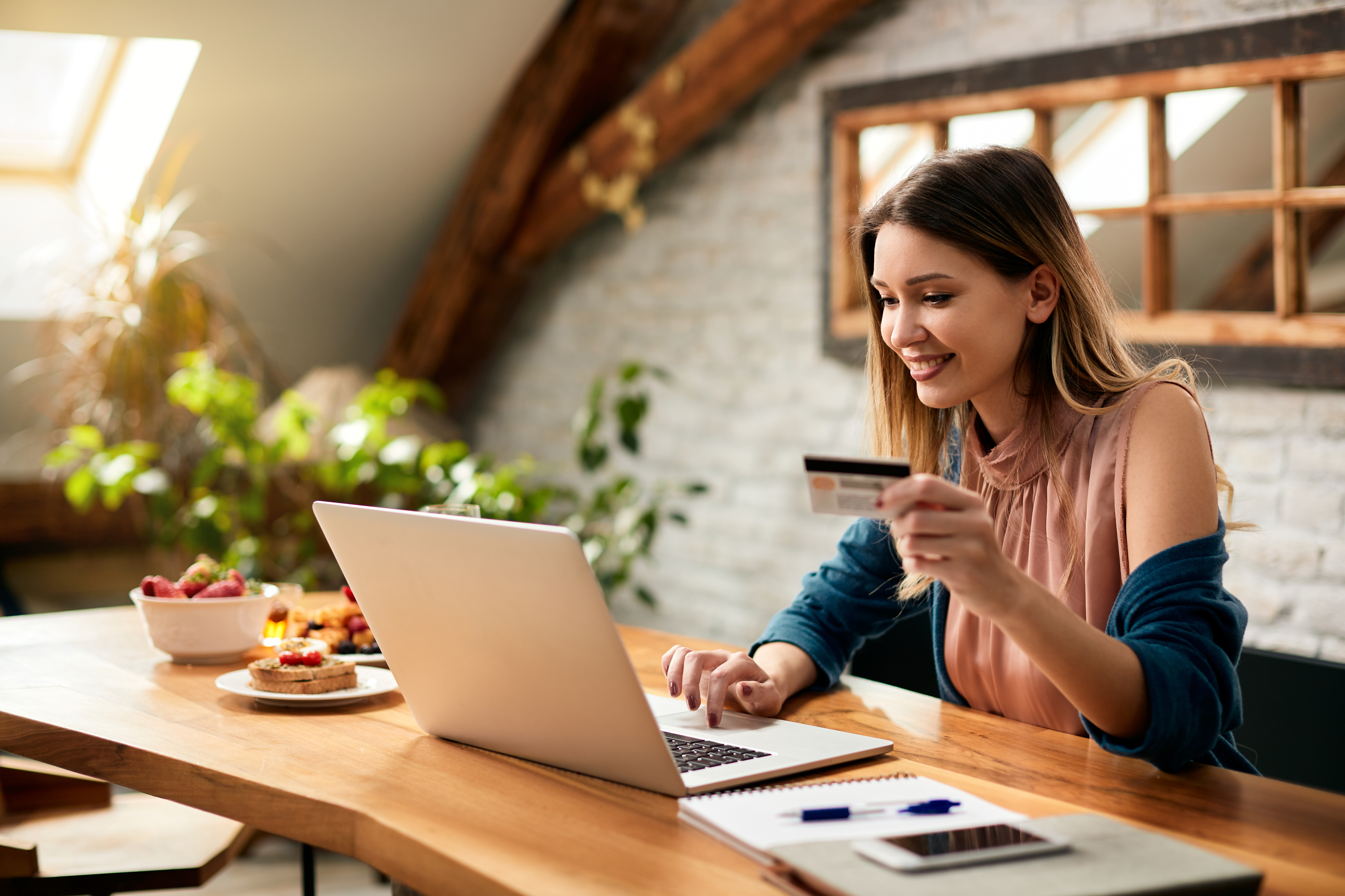 Young happy woman online shopping at home.