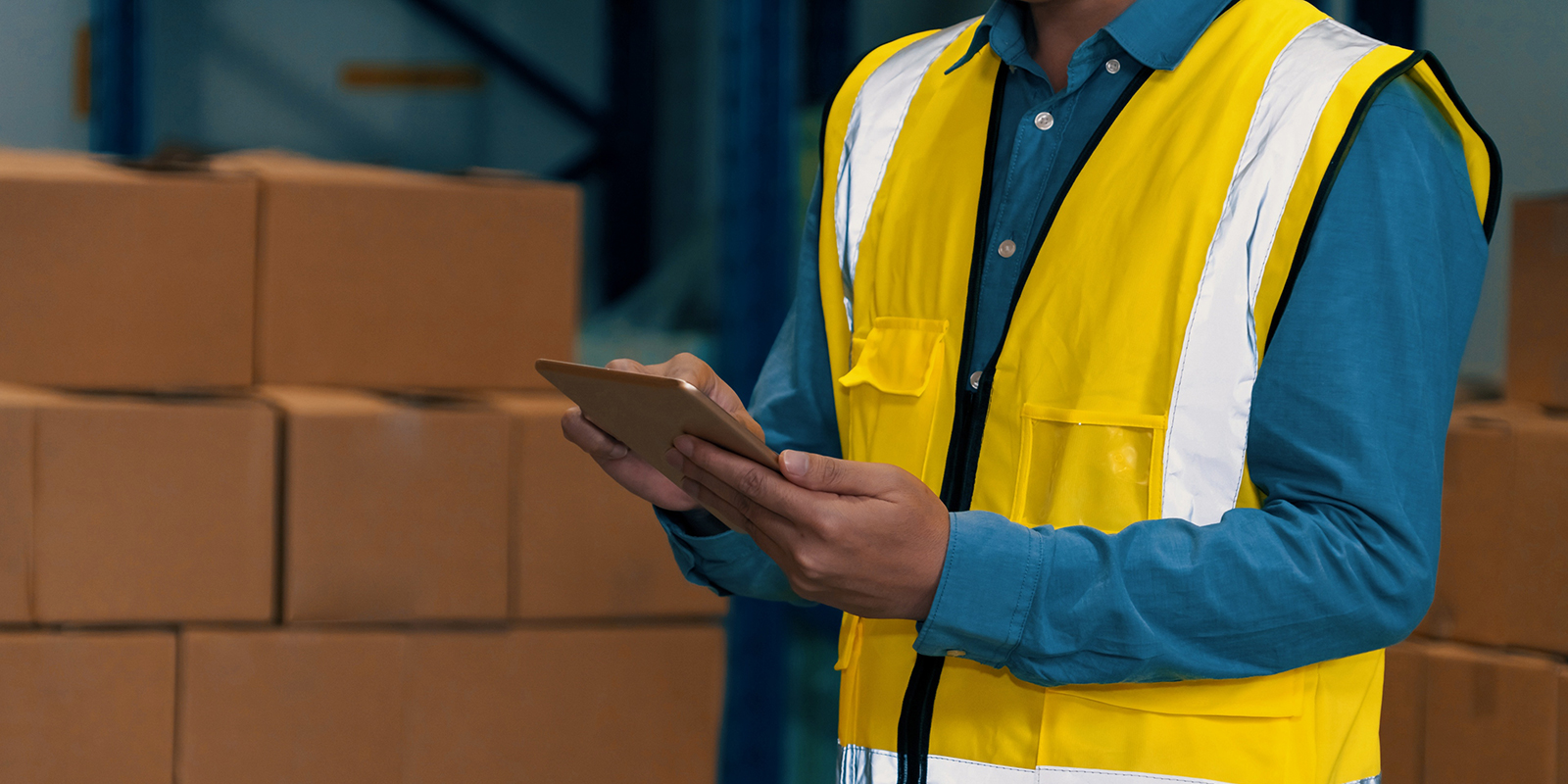 Asian warehouse worker checking packages in storehouse