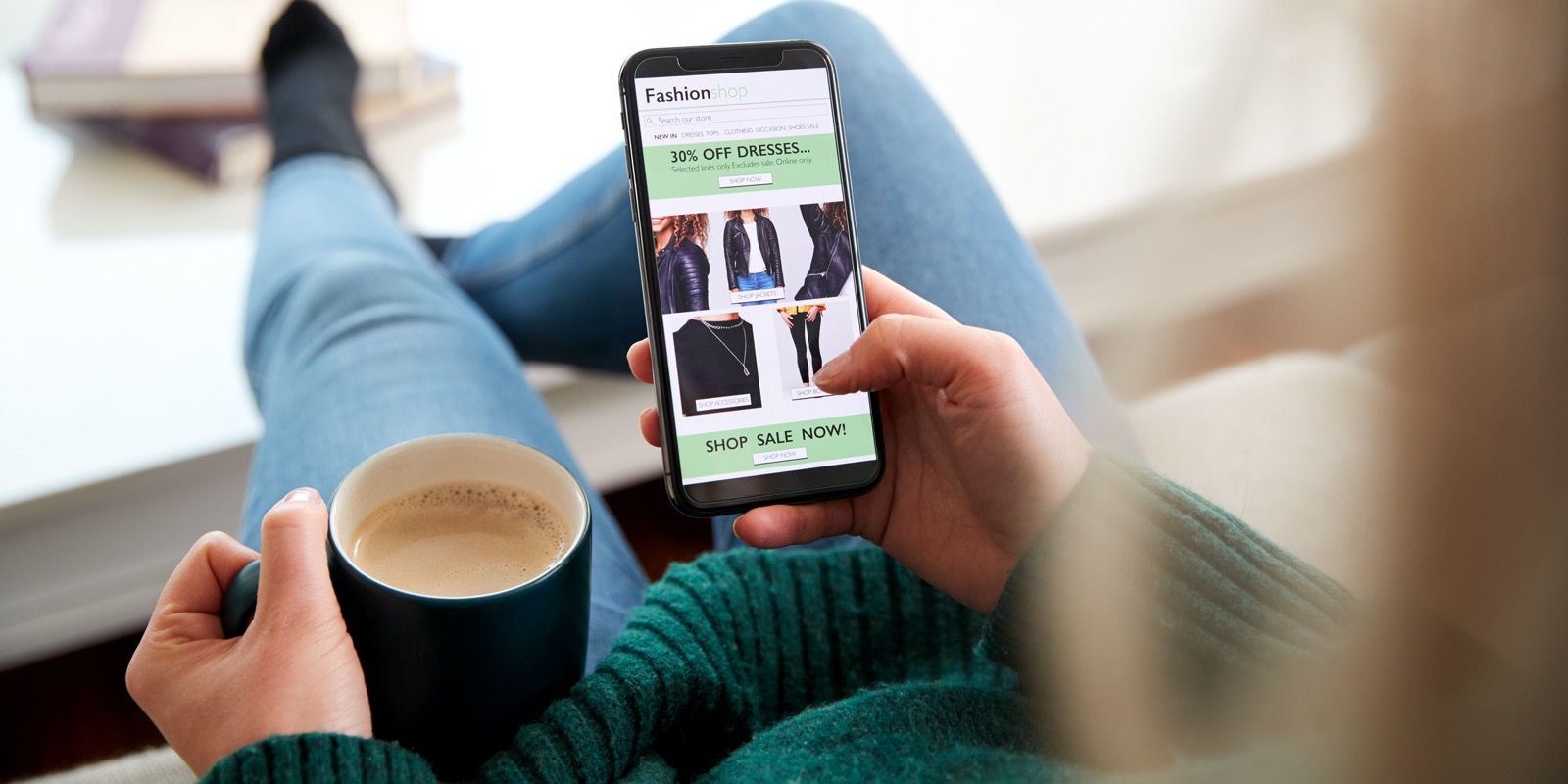 Close Up Of Woman Shopping For Clothes Online Using Mobile Phone App