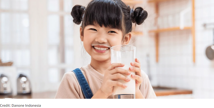 smiling child drinking milk