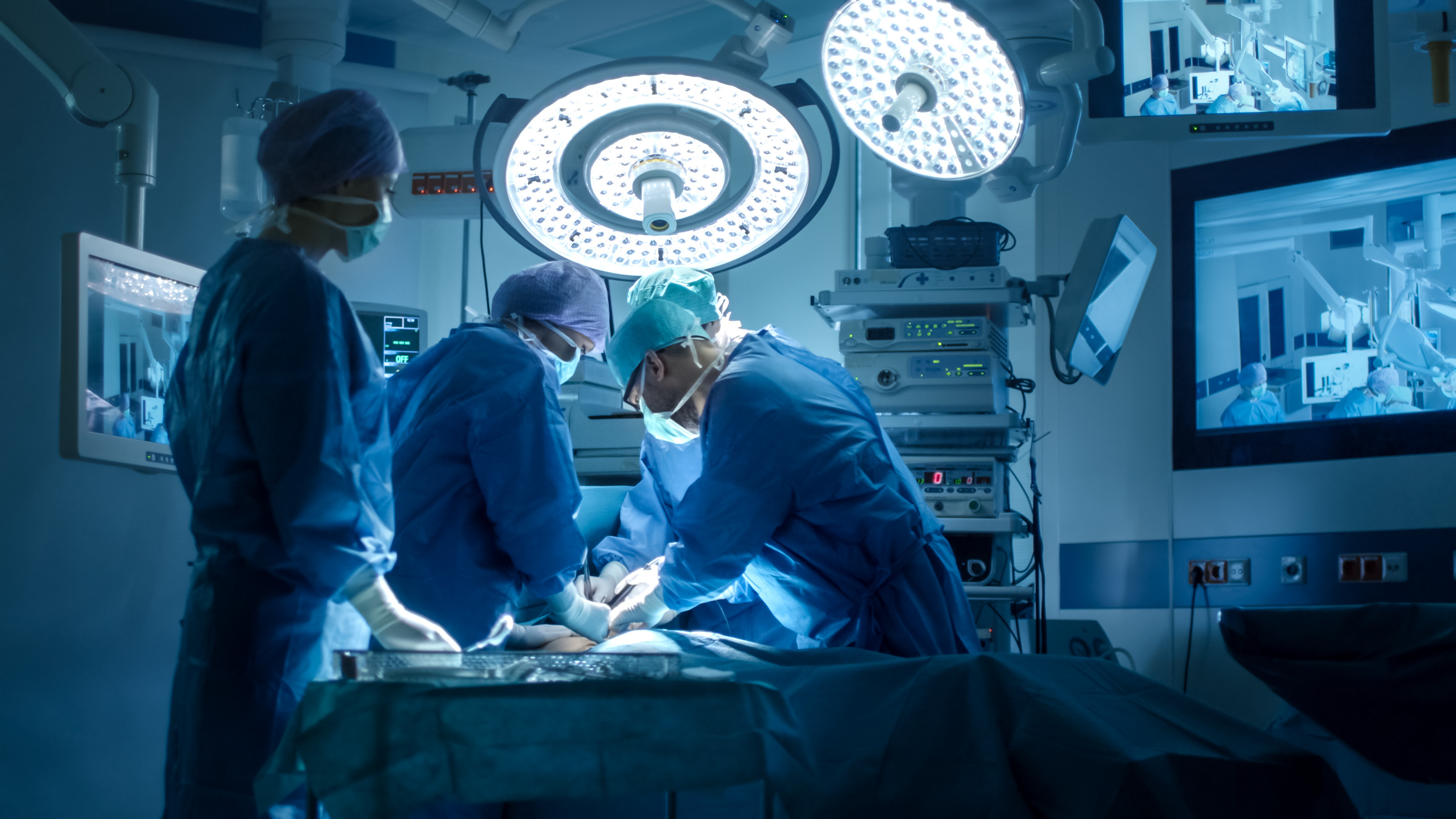 photo of three surgeons in an operating room