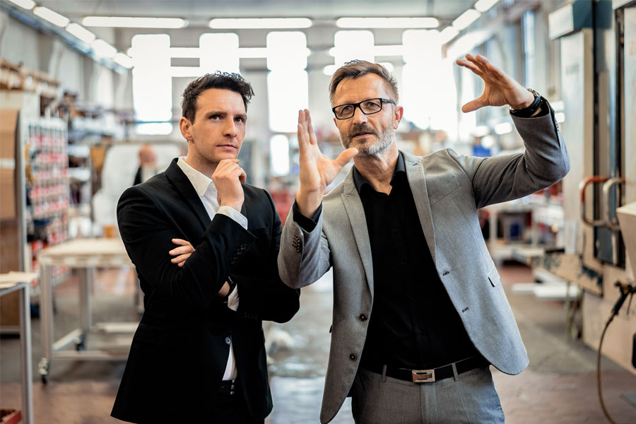 Two executives walking the plant floor in a manufacturing facility