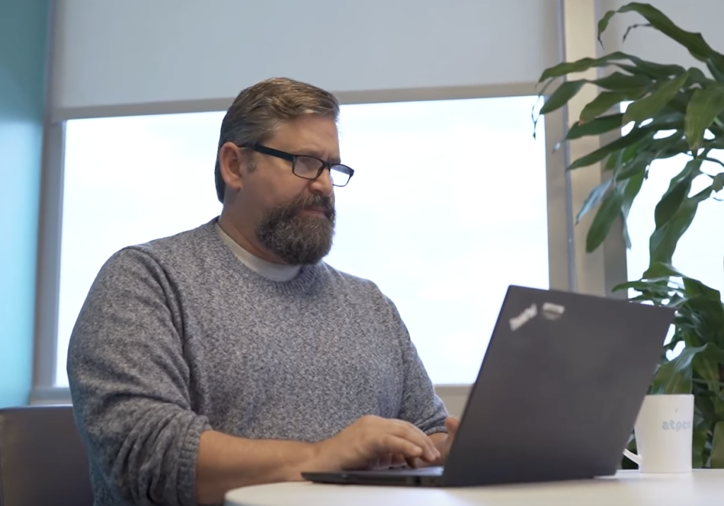 Alex Zoghlin at desk