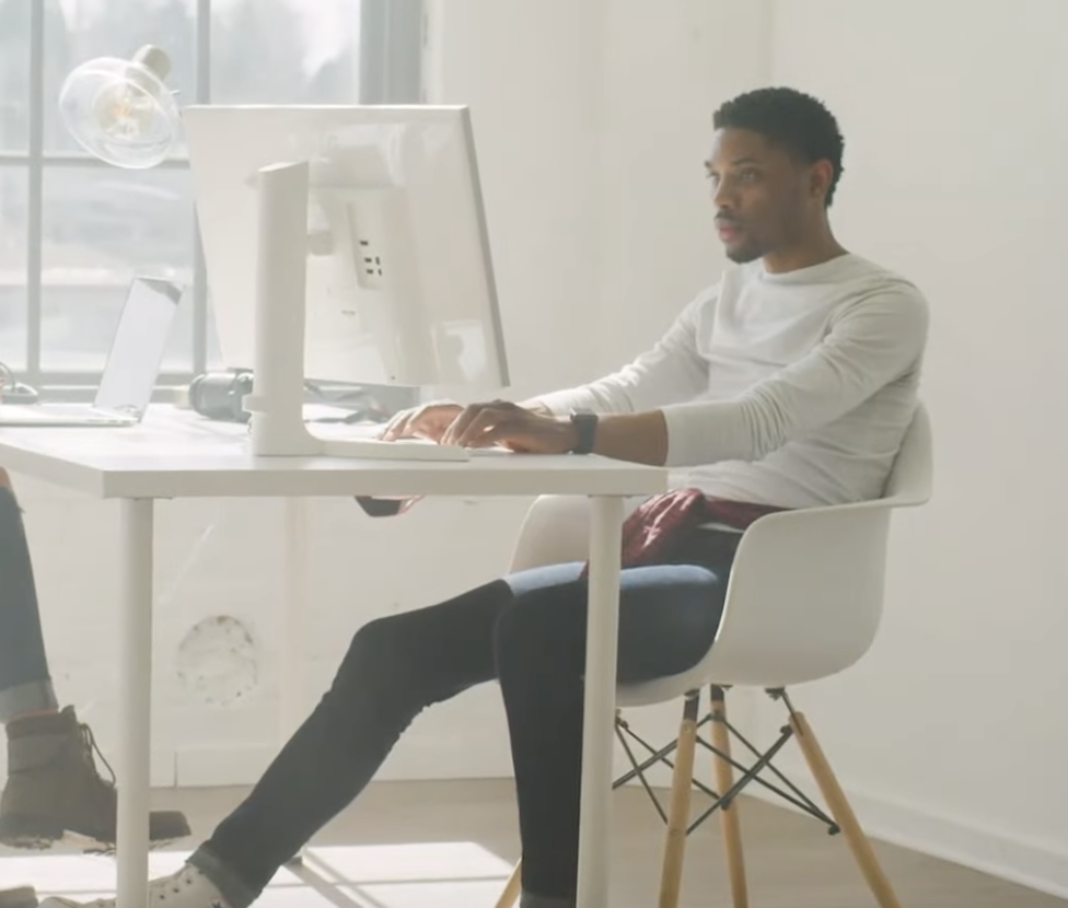 Video producer at desk editing a video