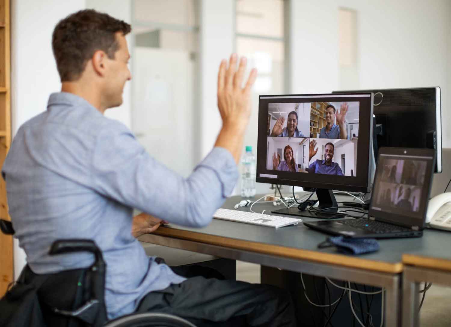 AWS Certified freelancer video chatting with his customers in an office setting