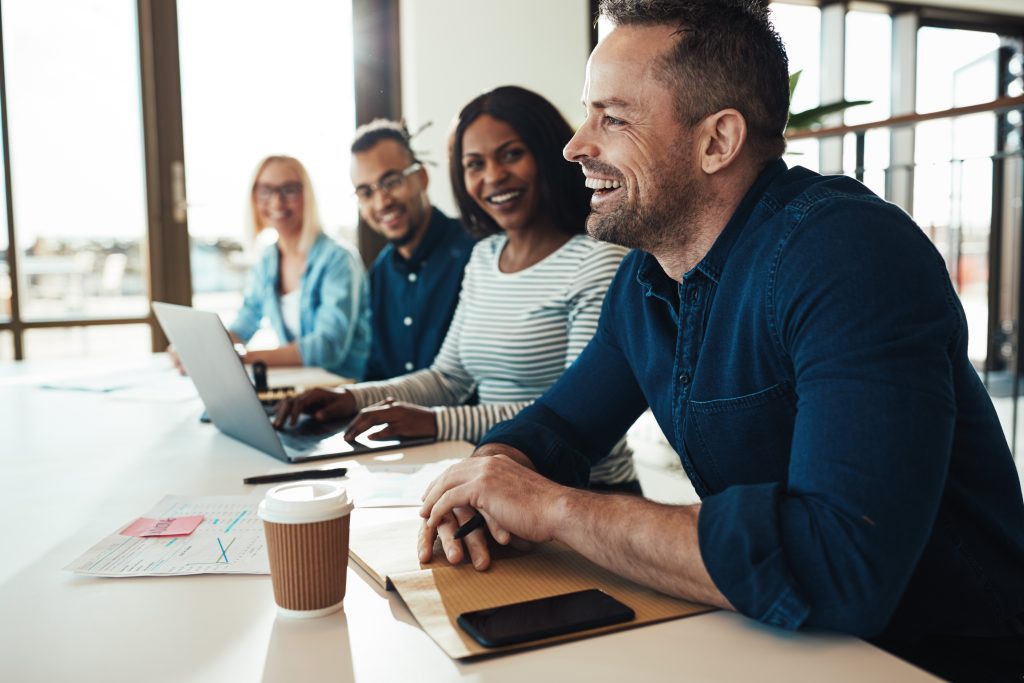 Group of 4 business associates sitting at table