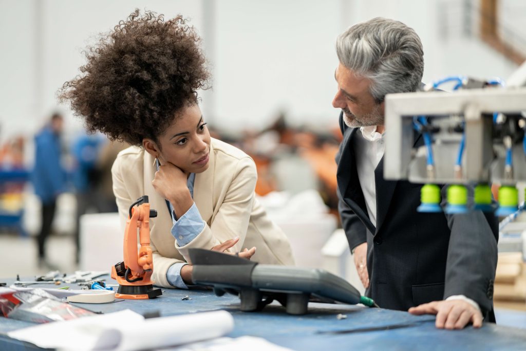 Co-workers leaning over a table analyzing information