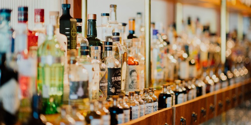 Bottles on a shelf lined up to show how bybe disrupts the adult beverage industry through its mobile app