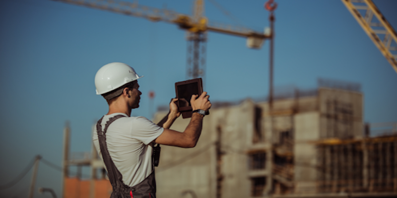 capmo construction worker at construction site taking photo