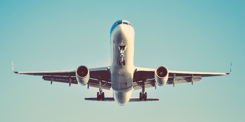 plane taking off against a blue sky background