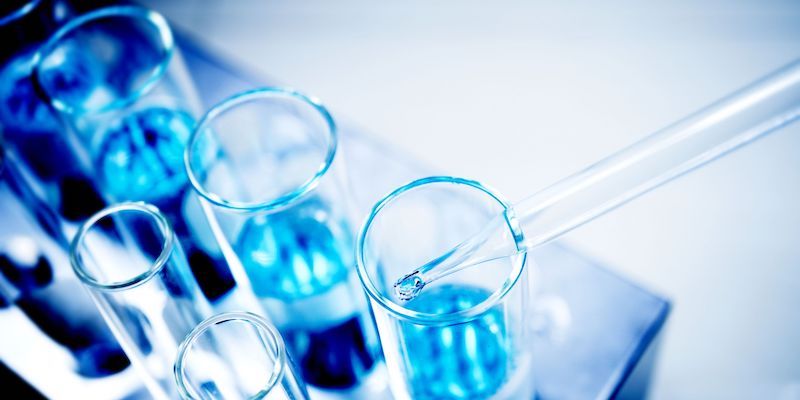 Image of a group of vials filled with blue liquid on a table