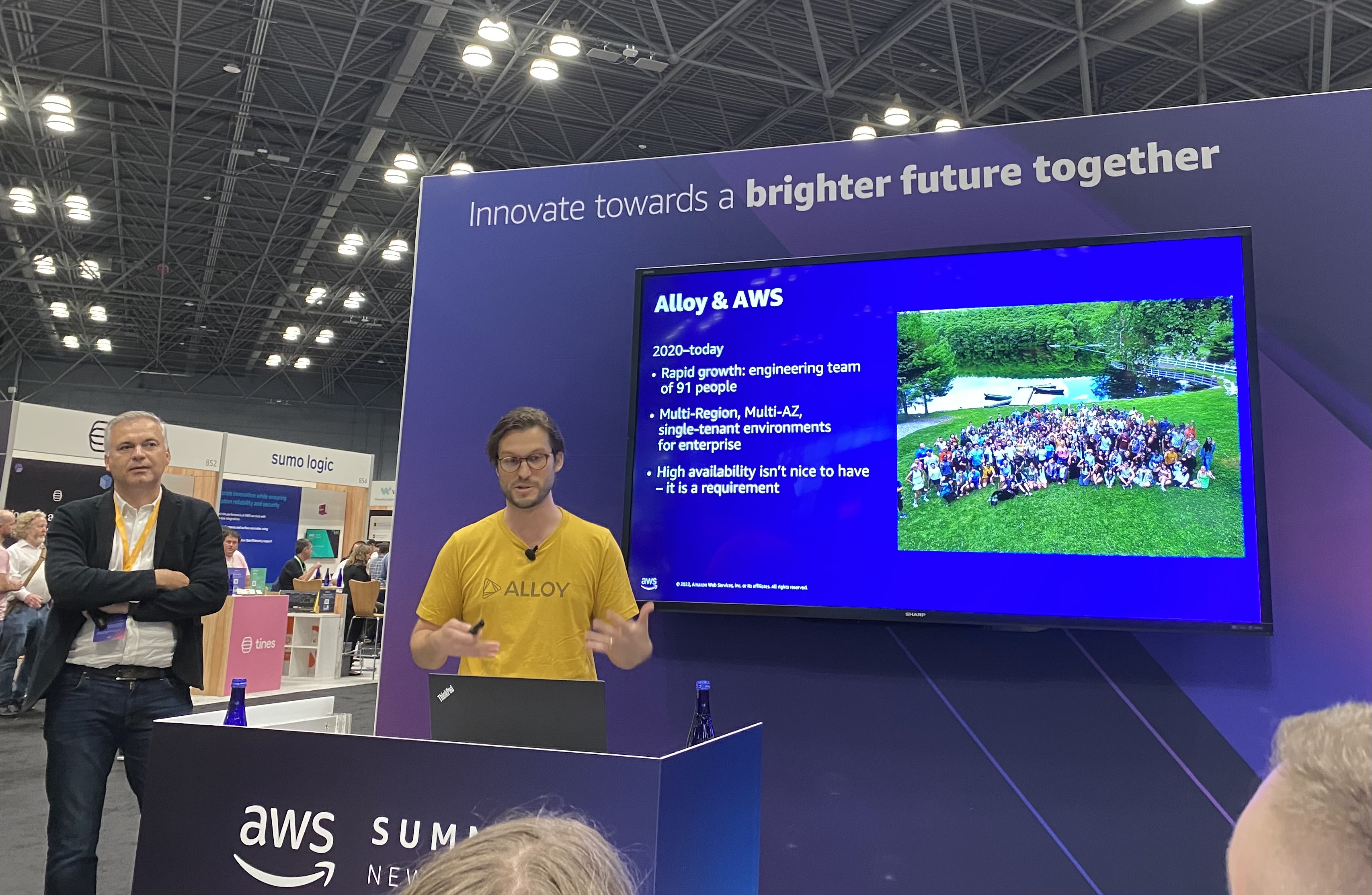 Charles Hearn speaks at the Alloy booth of the AWS Summit.