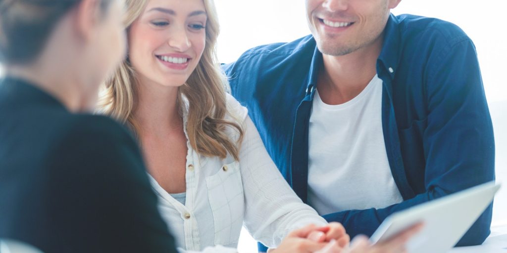 A couple reviewing papers with an insurance agent