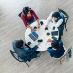 Aerial view of a small team collaborating at a desk