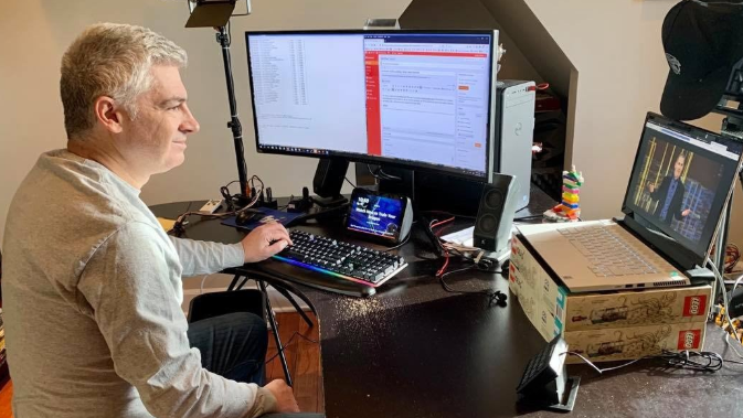 Jeff Barr sits in front of his computer monitors.