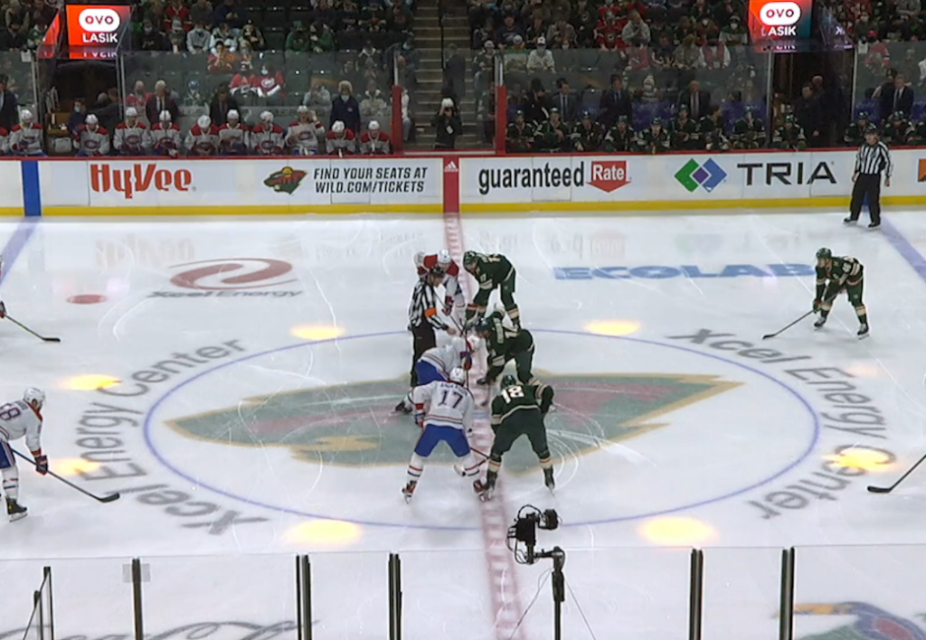 A photo showing a faceoff between two teams during an NHL game.