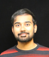 Professional headshot of K. Faryab Haye, Applied Scientist II at Amazon Health Services, wearing a red and gray striped sweater.