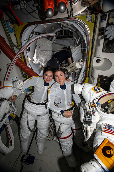 NASA astronauts Jessica Meir (left) and Christina Koch (right) put on their spacesuits as they prepare to leave the hatch of the International Space Station and begin the historical first-ever all-female spacewalk.