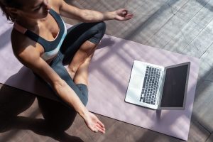 Girl doing yoga using an online platform