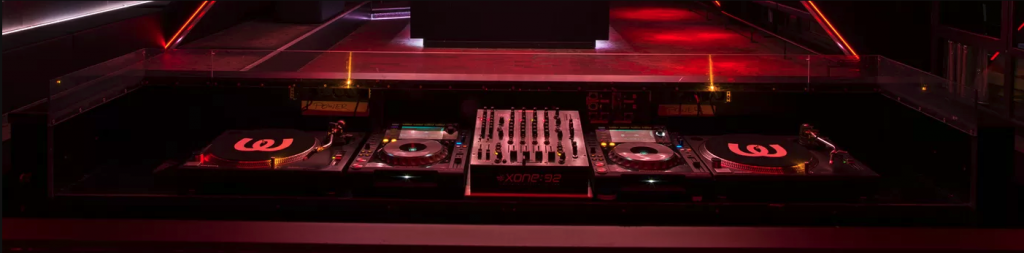 Mixing console in a dimly-lit nightclub