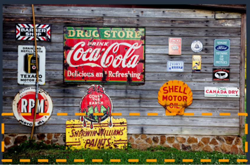 A wooden wall with metal signs on it